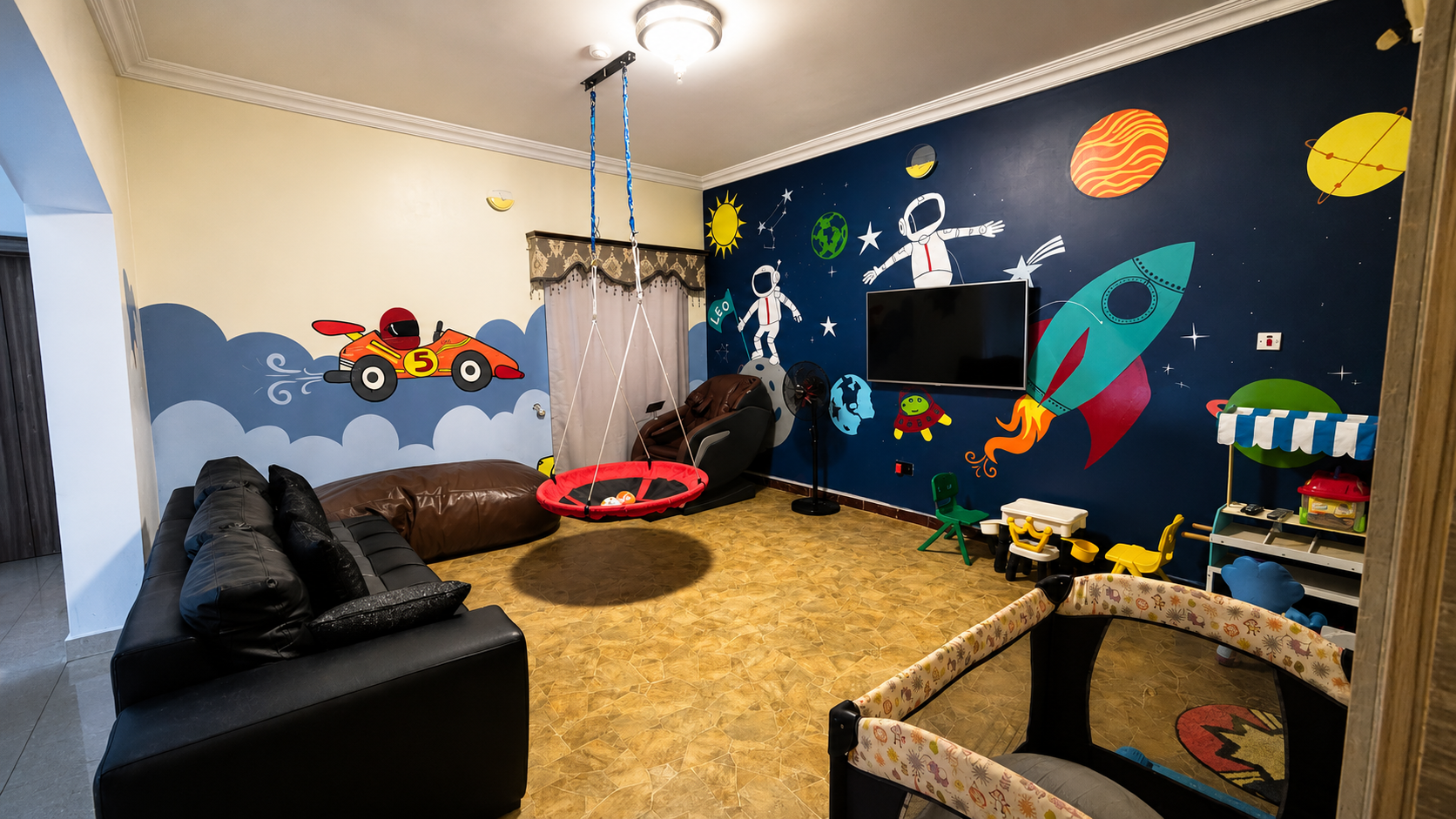 Gold 7 Residence kids living room with space-themed mural, swing and play area