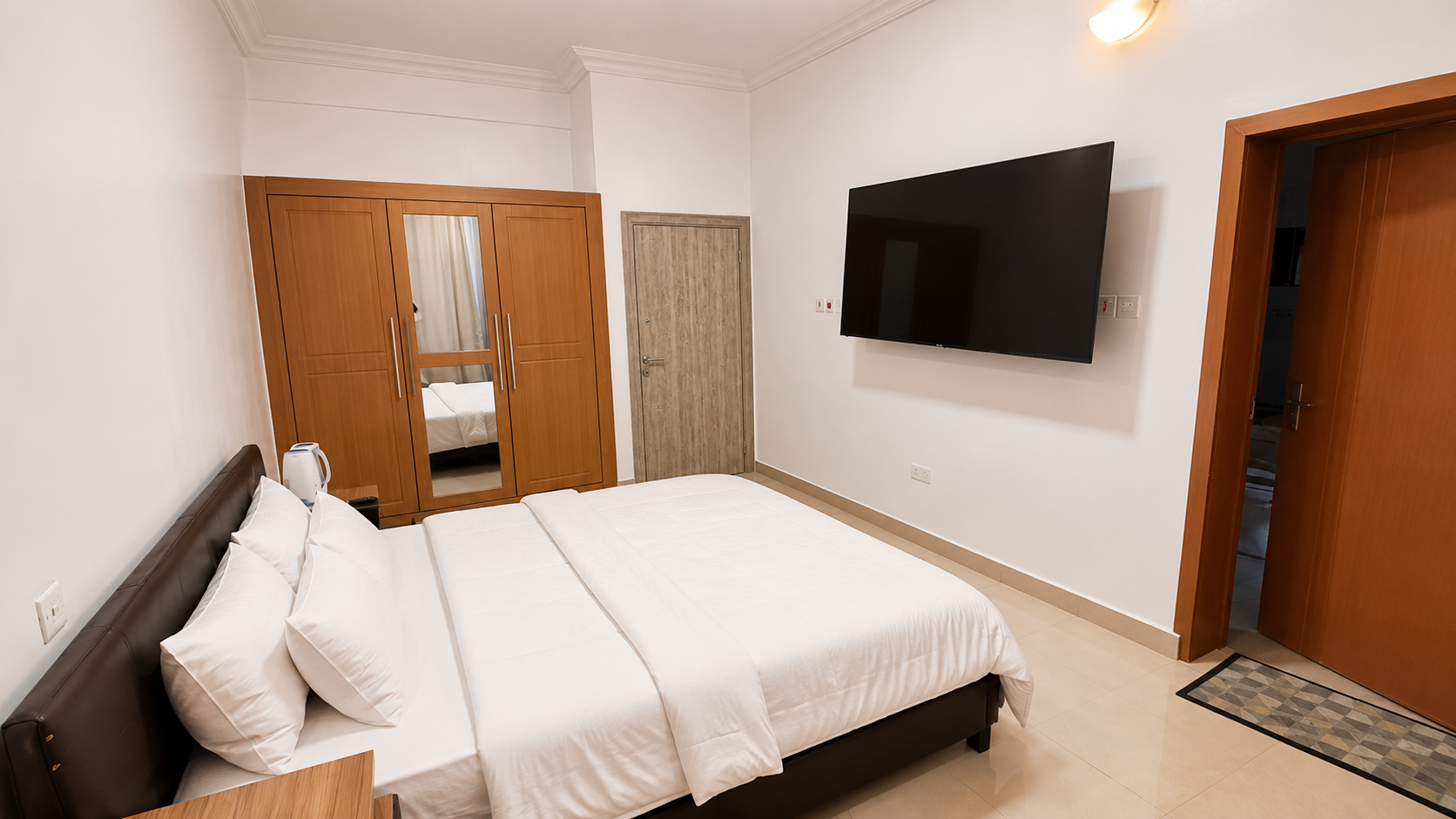 Gold 7 Residence second bedroom with wardrobe and television