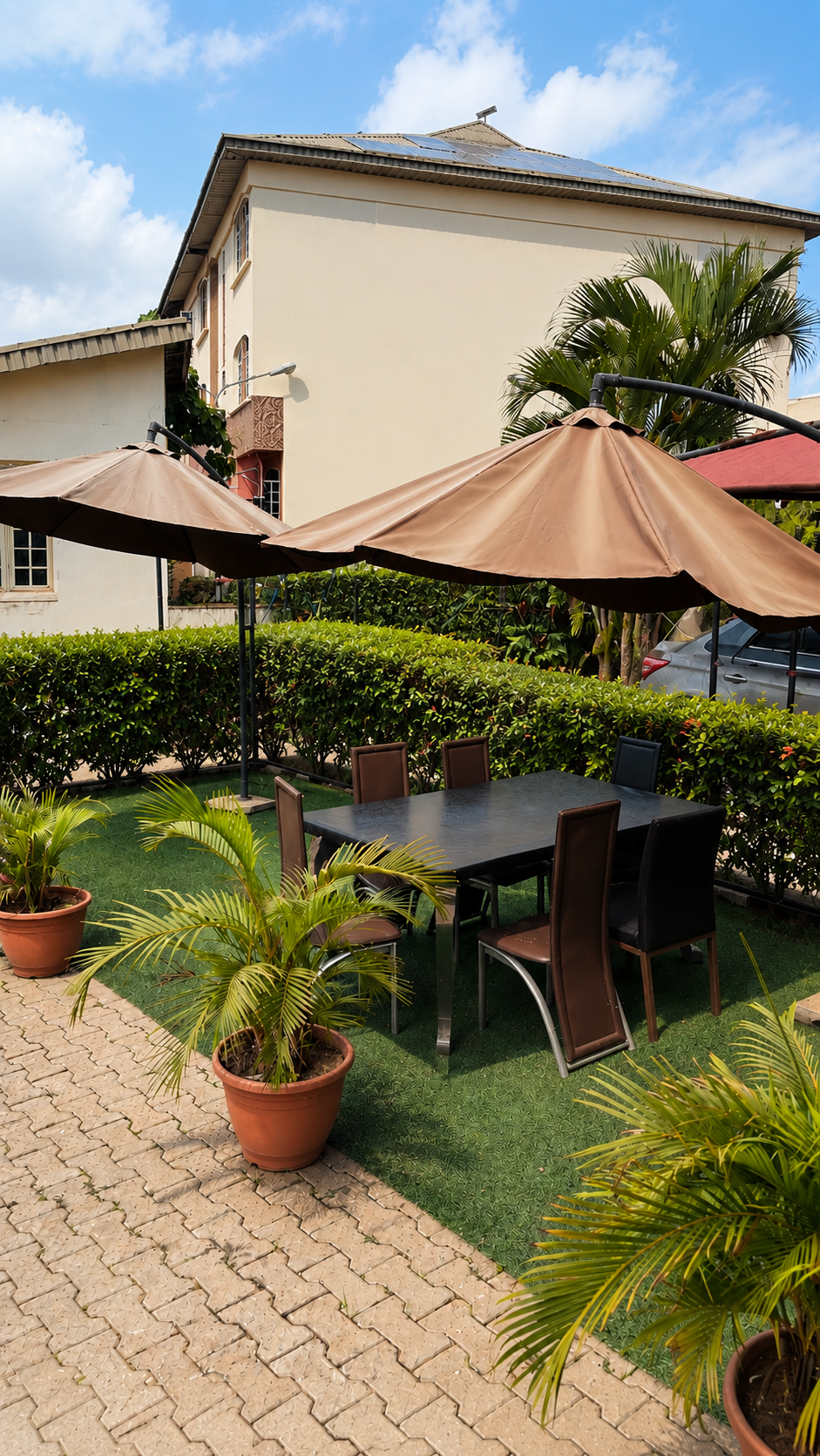 Gold 7 Residence private outdoor dining area with umbrellas and greenery