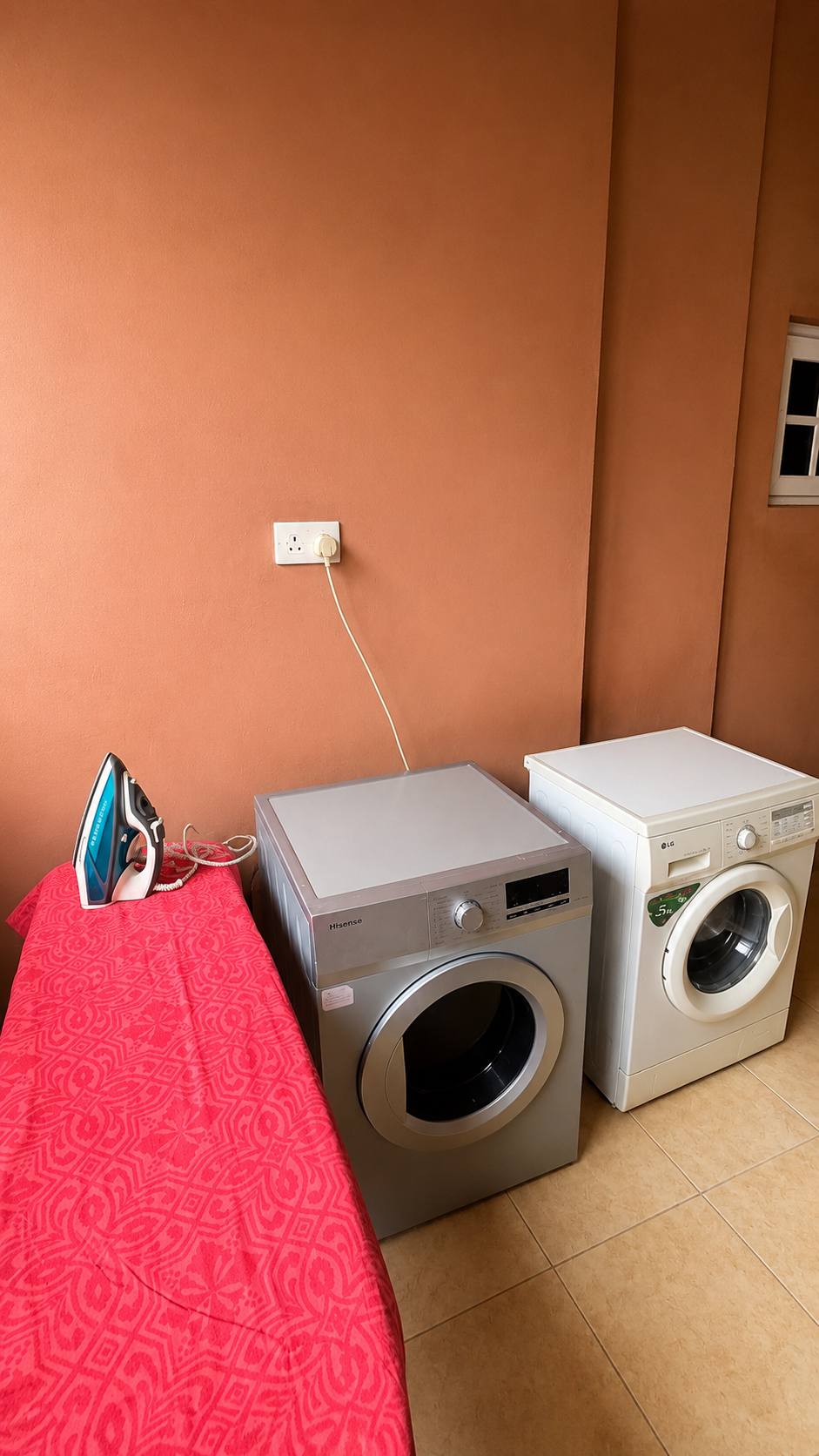 Gold 7 Residence laundry room with washing machine, dryer and ironing board