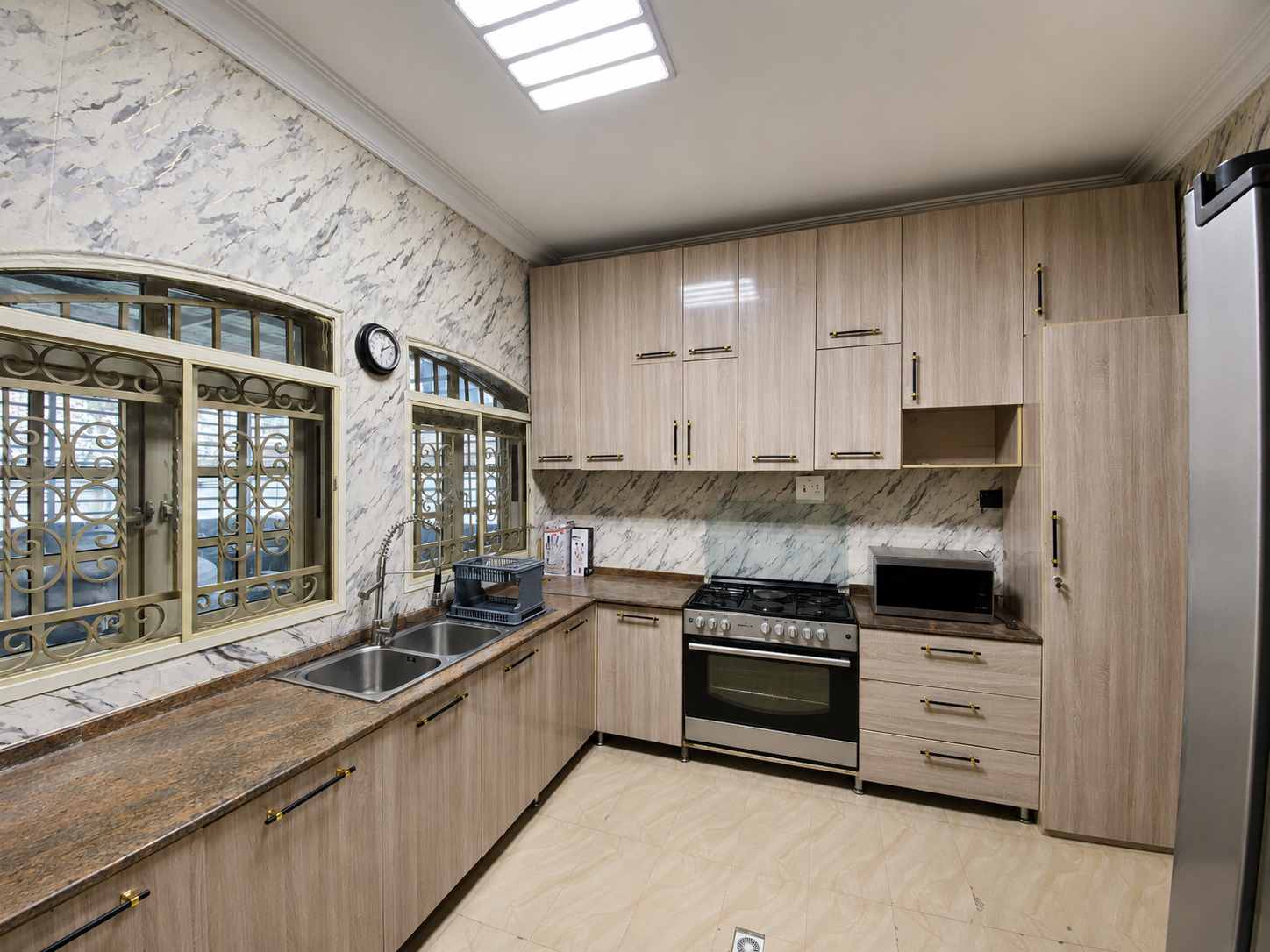 Gold 7 Residence fitted kitchen with gas cooker, microwave and storage
